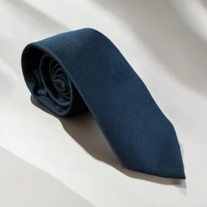 Long black funeral tie on white background