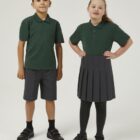 Children wearing Bottle Trutex school polo shirt as part of a school uniform outfit