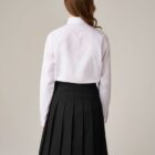 Back view of girls school blouse showing straight hem and fit